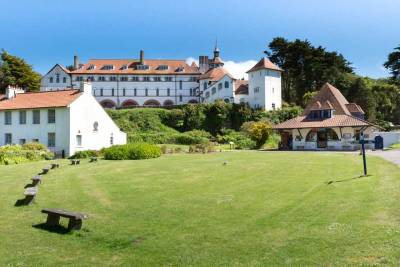 A view across the lawn to the buildings of Caldey up to the monastry