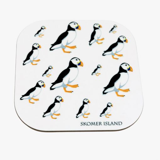 white coaster with graphic art black and white puffins