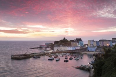 pink mackerel sky at sunrise above tenby harbour wales